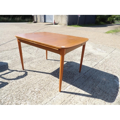 132 - AN extending teak dining table by Schreiber