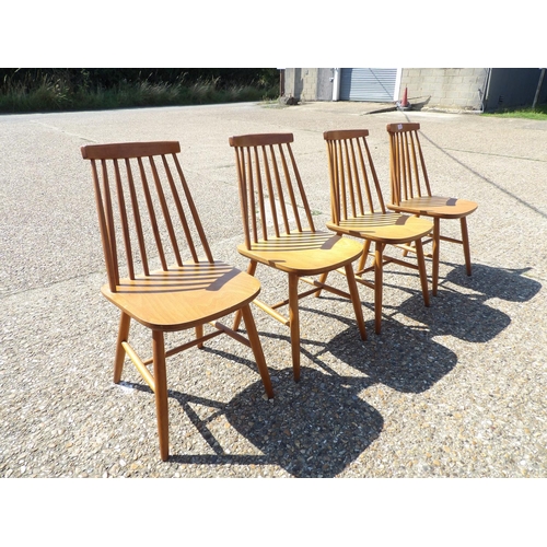 135 - A set of four mid century stick back kitchen chairs