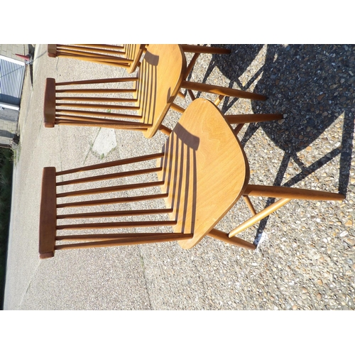 135 - A set of four mid century stick back kitchen chairs