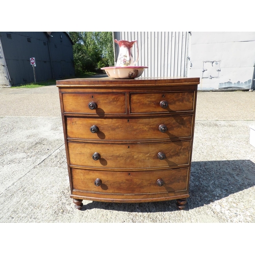 140 - A victorian mahogany bow font chest of drawers together with ceramic jug and bowl102x40x112