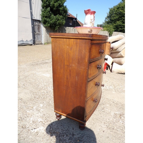 140 - A victorian mahogany bow font chest of drawers together with ceramic jug and bowl102x40x112