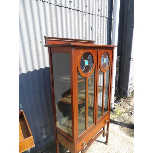 148 - A mahogany arts and crafts display cabinet with stained glass panels