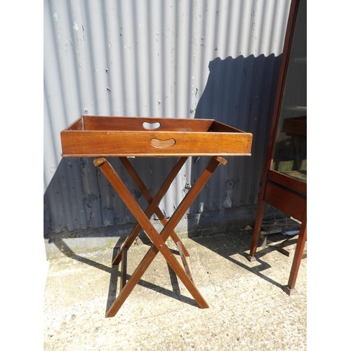 149 - A mahogany butlers serving tray on folding stand