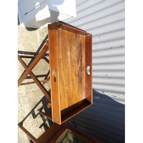 149 - A mahogany butlers serving tray on folding stand