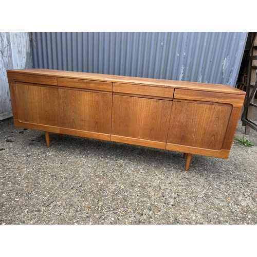 164 - A mid century teak sideboard with four drawers over four cupboard doors  200x45 x78