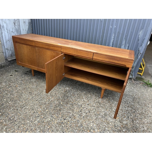 164 - A mid century teak sideboard with four drawers over four cupboard doors  200x45 x78