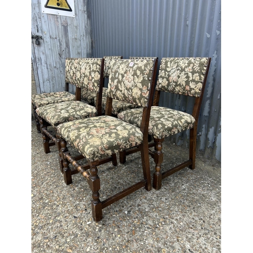 167 - A set of six solid oak dining chairs with green pattern seats with brass studwork