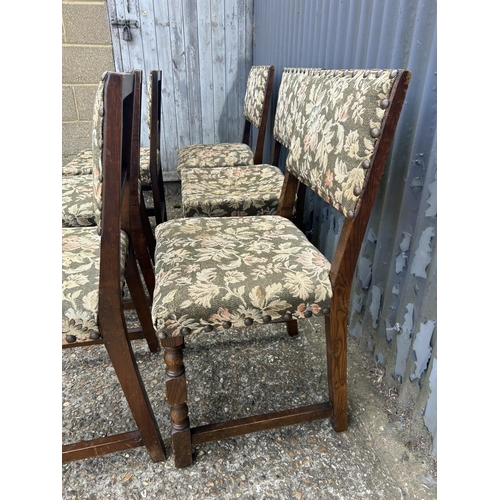 167 - A set of six solid oak dining chairs with green pattern seats with brass studwork