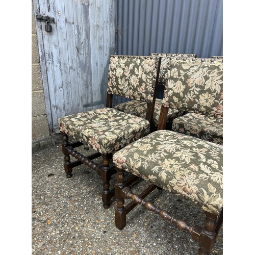 167 - A set of six solid oak dining chairs with green pattern seats with brass studwork