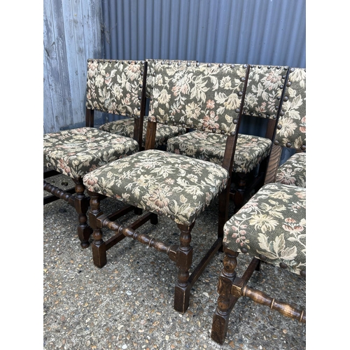 167 - A set of six solid oak dining chairs with green pattern seats with brass studwork