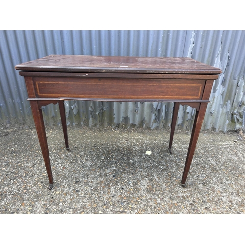 172 - An Edwardian mahogany fold over card table