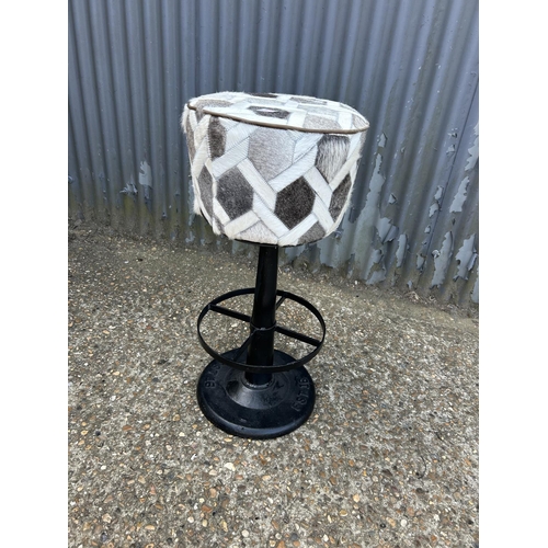 173 - An iron based bar stool with grey fur upholstered seat