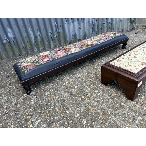 176 - Two long mahogany frame footstools with upholstered tops