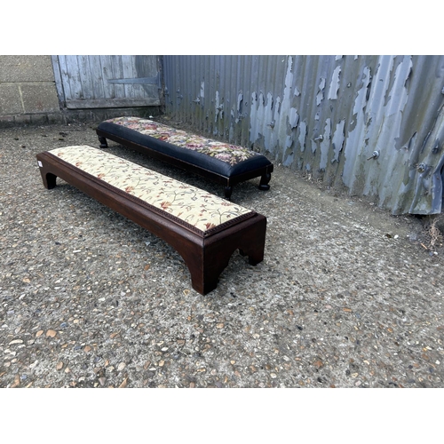 176 - Two long mahogany frame footstools with upholstered tops