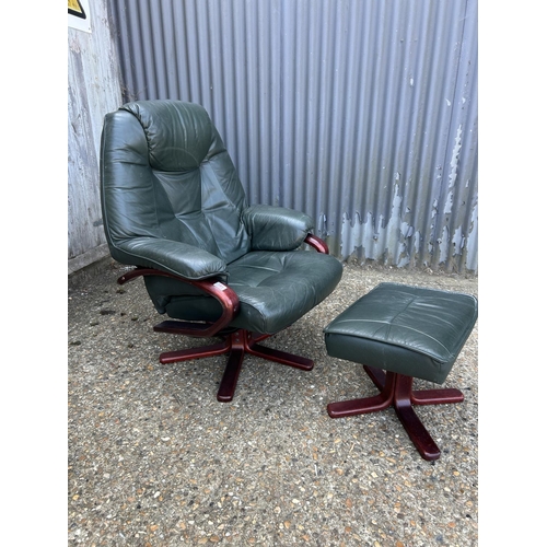 181 - A good quality green leather easy chair with footstool