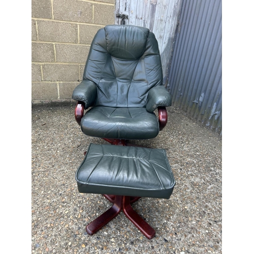 181 - A good quality green leather easy chair with footstool