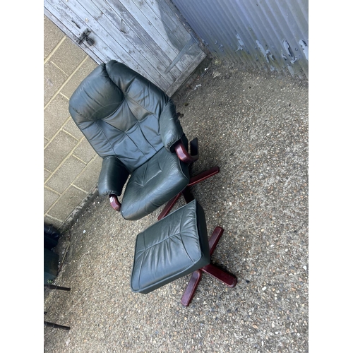 181 - A good quality green leather easy chair with footstool