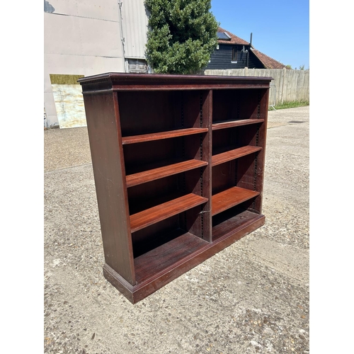 204 - A repro mahogany opem fronted bookcase 122x30x109