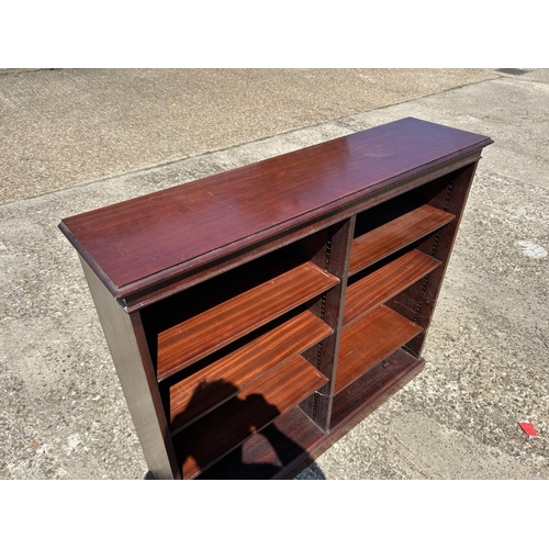 204 - A repro mahogany opem fronted bookcase 122x30x109