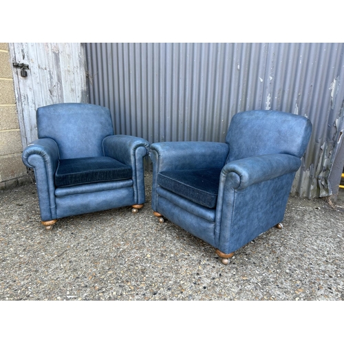 206 - A pair of 20th century blue vinyl armchairs with cushion seats