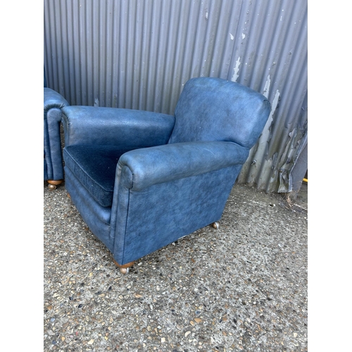 206 - A pair of 20th century blue vinyl armchairs with cushion seats