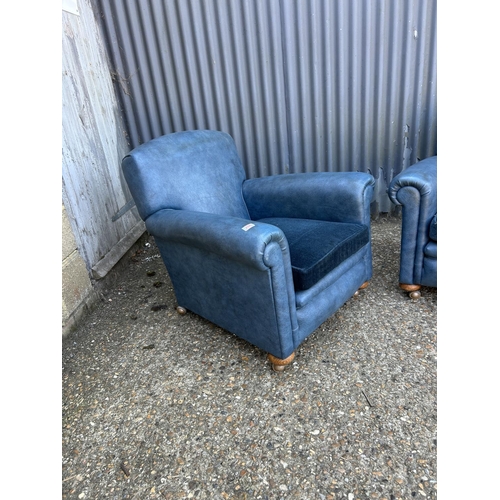 206 - A pair of 20th century blue vinyl armchairs with cushion seats