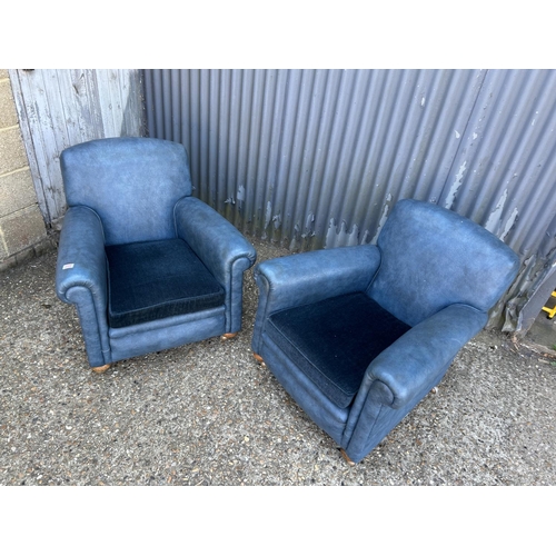 206 - A pair of 20th century blue vinyl armchairs with cushion seats