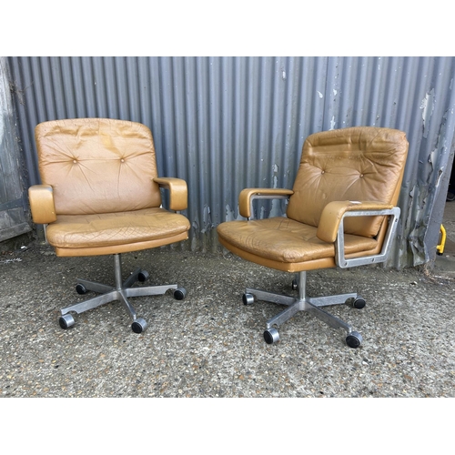 211 - A pair of mid century  aluminium framed swivel chairs with tan brown leather seats