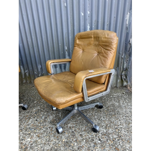 211 - A pair of mid century  aluminium framed swivel chairs with tan brown leather seats