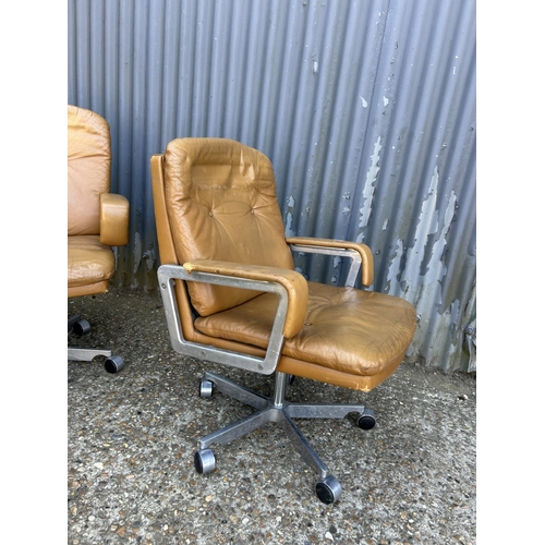 211 - A pair of mid century  aluminium framed swivel chairs with tan brown leather seats