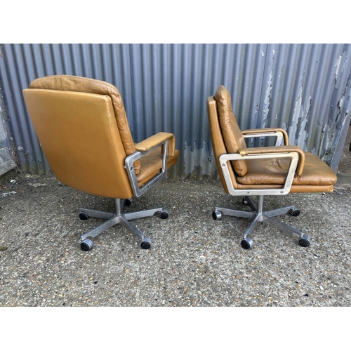 211 - A pair of mid century  aluminium framed swivel chairs with tan brown leather seats