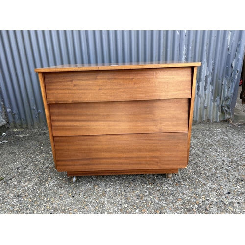 212 - A teak chest of three drawers