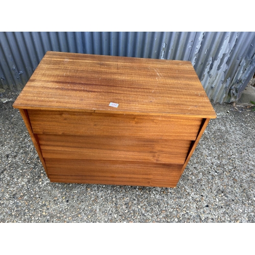 212 - A teak chest of three drawers