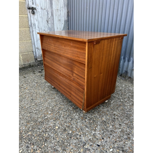 212 - A teak chest of three drawers