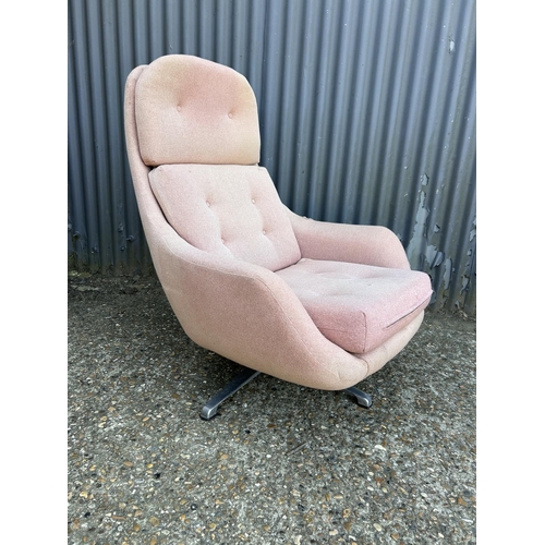 216 - A mid century red upholstered retro swivel chair on aluminium star base