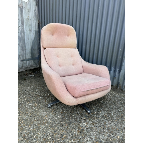 216 - A mid century red upholstered retro swivel chair on aluminium star base