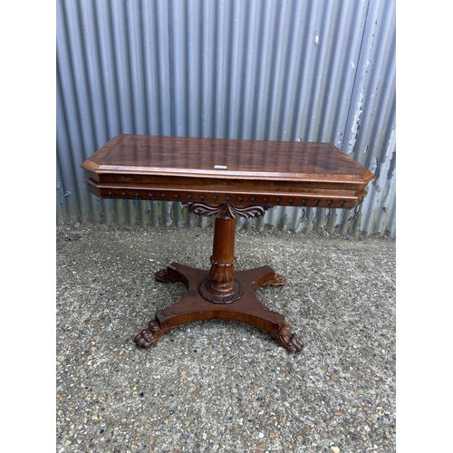 217 - A Victorian mahogany card table with fold over top and blue baize surface