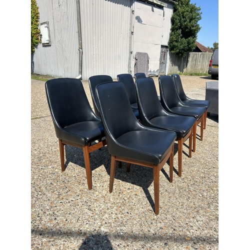 220 - A set of 8 mid century teak framed dining chairs with black vinyl upholstery