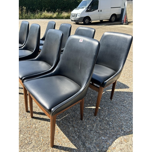 220 - A set of 8 mid century teak framed dining chairs with black vinyl upholstery