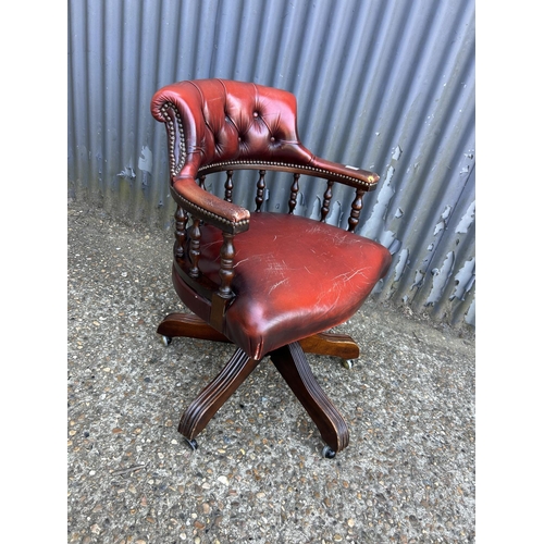 222 - A red leather chesterfield swivel chair captains chair