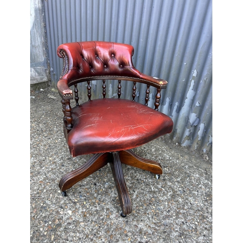 222 - A red leather chesterfield swivel chair captains chair