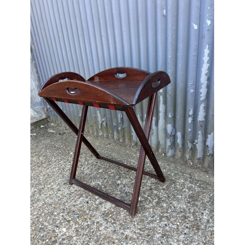 232 - A mahogany butlers tray table on folding stand