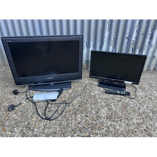 245 - Two flat screen tvs with remote controls