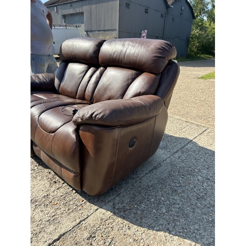 252 - A good quality brown leather two seater sofa with electric recline and foot rests