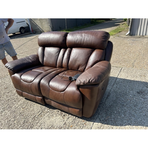 252 - A good quality brown leather two seater sofa with electric recline and foot rests