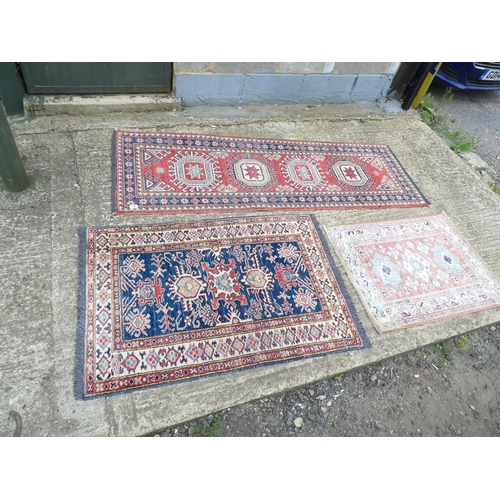 49 - An Aztec patter runner 190x62 together with two small red pattern rugs