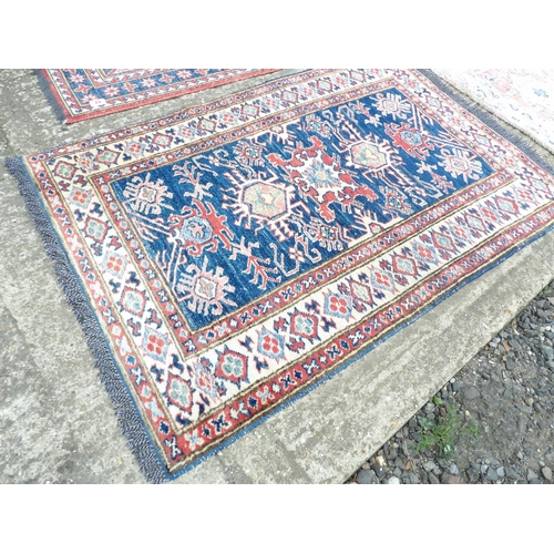 49 - An Aztec patter runner 190x62 together with two small red pattern rugs