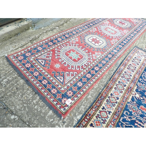 49 - An Aztec patter runner 190x62 together with two small red pattern rugs