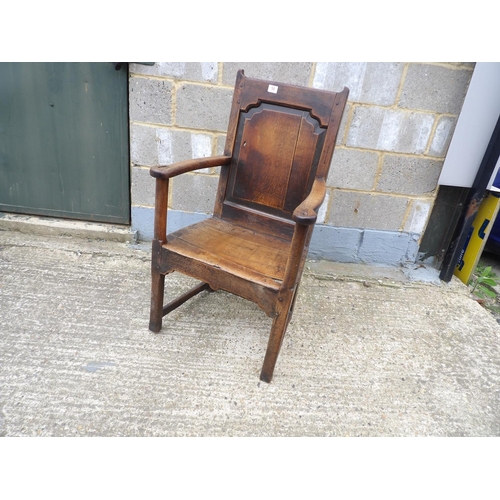 58 - An antique oak panel back chair