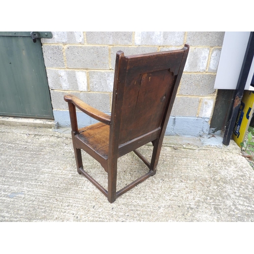 58 - An antique oak panel back chair